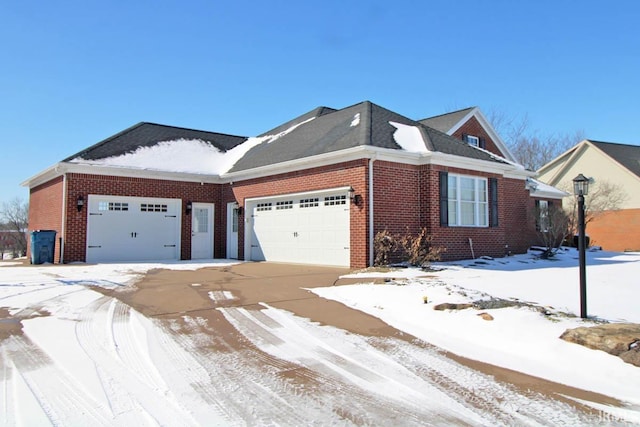 view of front of property with brick siding, driveway, and an attached garage