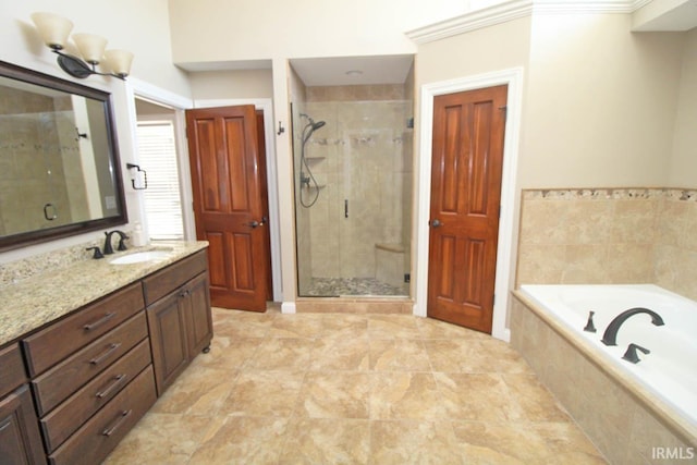 bathroom featuring a garden tub, crown molding, a shower stall, and vanity