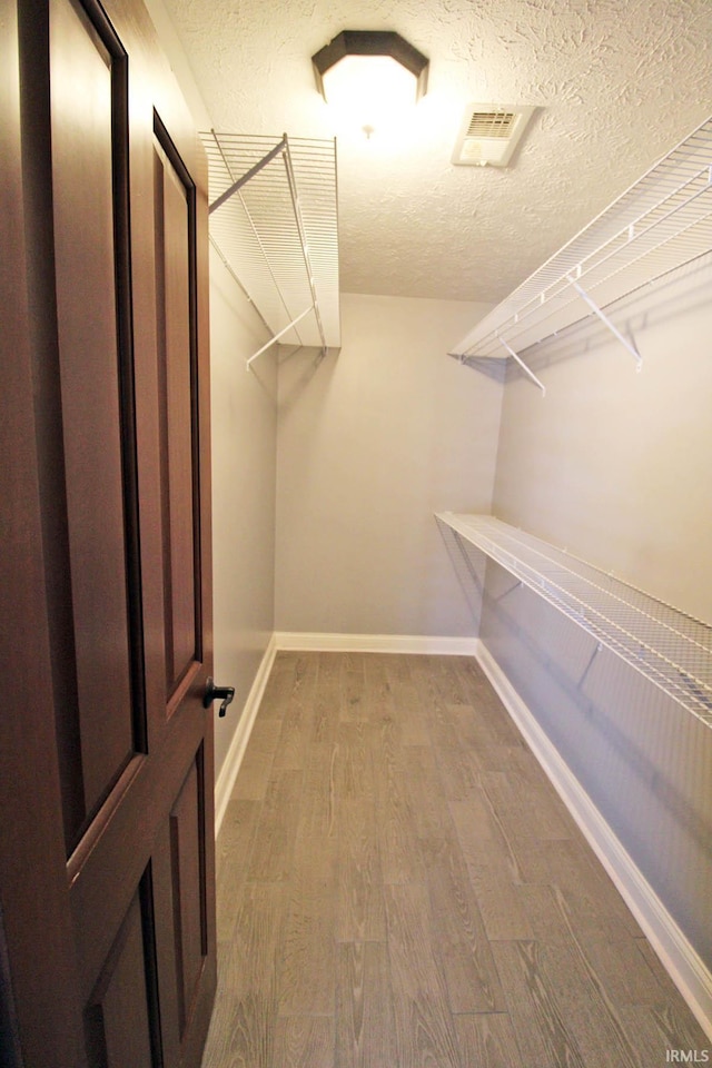 spacious closet with wood finished floors