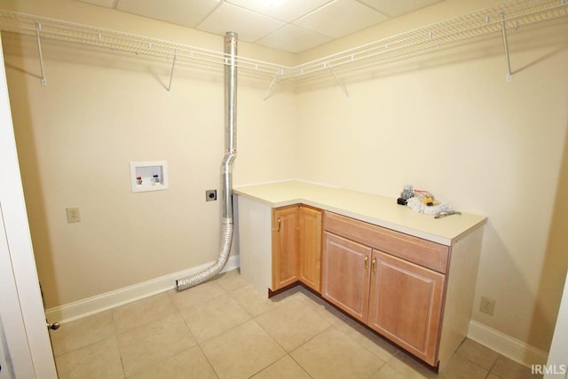 laundry area featuring light tile patterned floors, hookup for a washing machine, hookup for an electric dryer, baseboards, and cabinet space