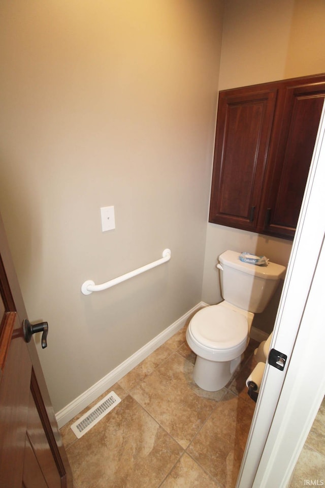 bathroom with visible vents, toilet, baseboards, and tile patterned floors