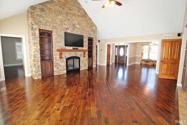 unfurnished living room with high vaulted ceiling, a stone fireplace, a ceiling fan, baseboards, and dark wood finished floors