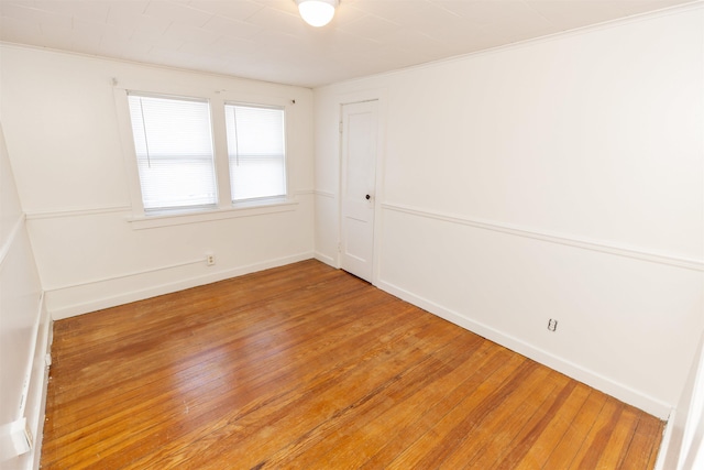 spare room with wood finished floors and baseboards