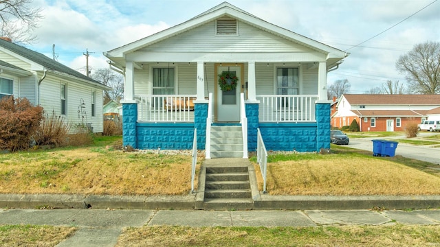 view of front facade with a porch and a front lawn