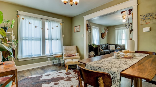 dining space with wood finished floors and baseboards