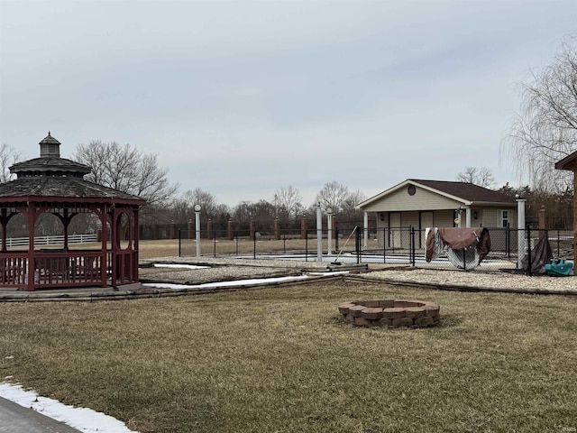 view of play area featuring a yard, an outdoor fire pit, a gazebo, and fence