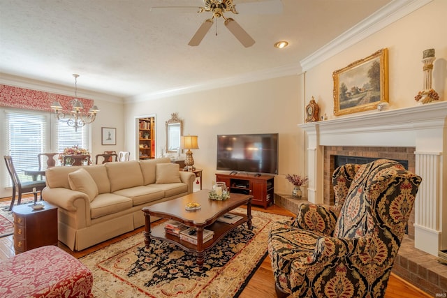 living room with light wood-style floors, a fireplace, and ornamental molding