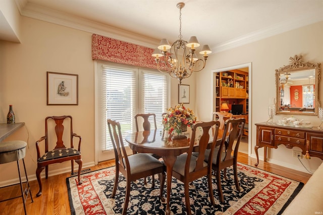 dining area with a chandelier, visible vents, light wood-style floors, baseboards, and crown molding