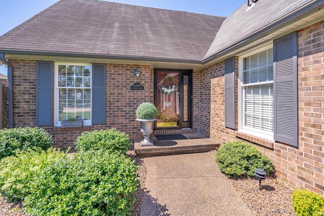 doorway to property with brick siding