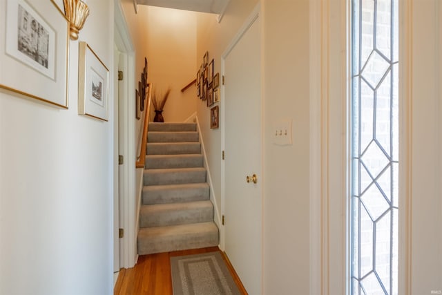 corridor featuring stairway and wood finished floors