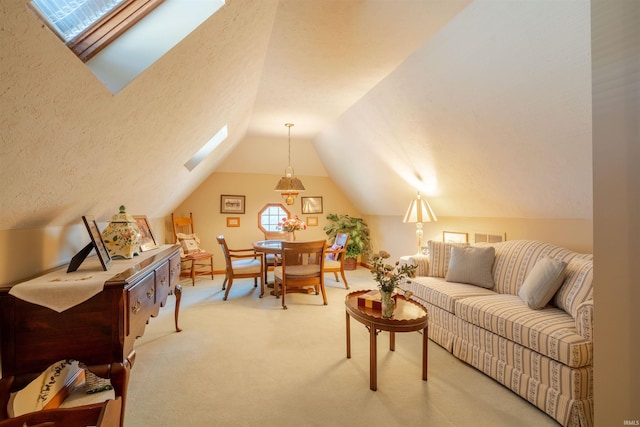 interior space with carpet floors, lofted ceiling with skylight, and a textured ceiling