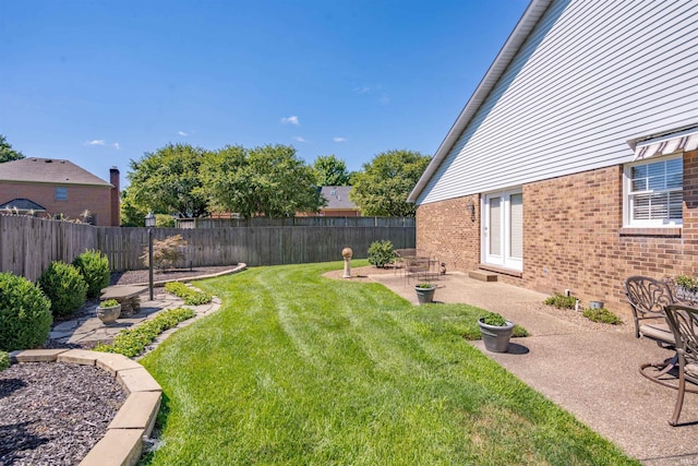 view of yard featuring a patio area and a fenced backyard