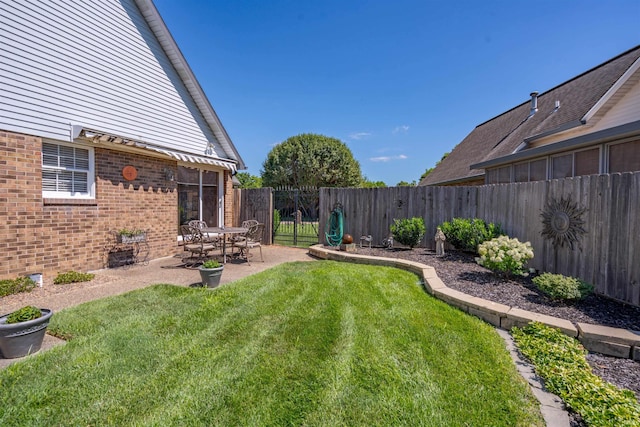 view of yard with a patio and a fenced backyard