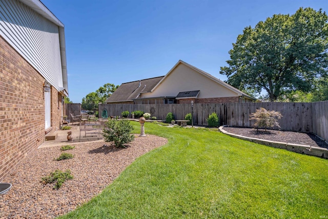 view of yard with a patio area and a fenced backyard