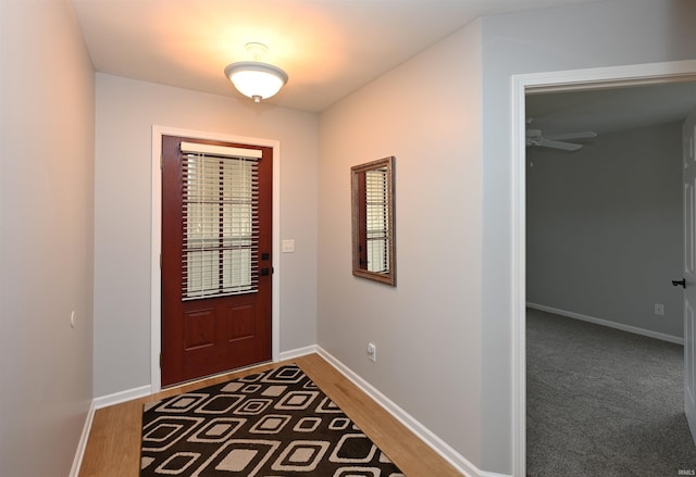 doorway to outside featuring wood finished floors and baseboards