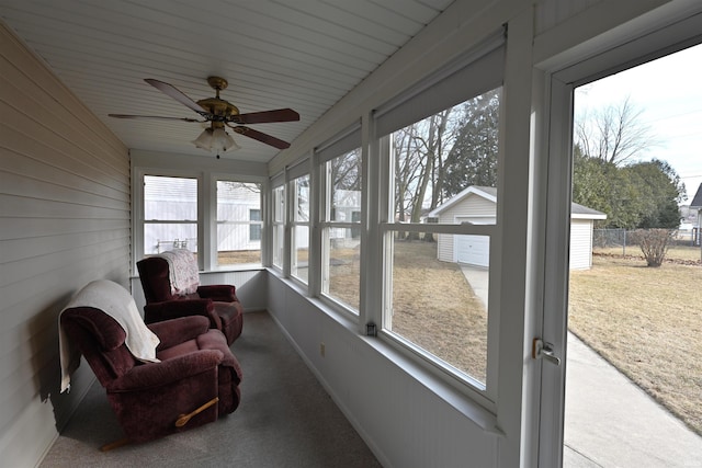 sunroom / solarium with a ceiling fan