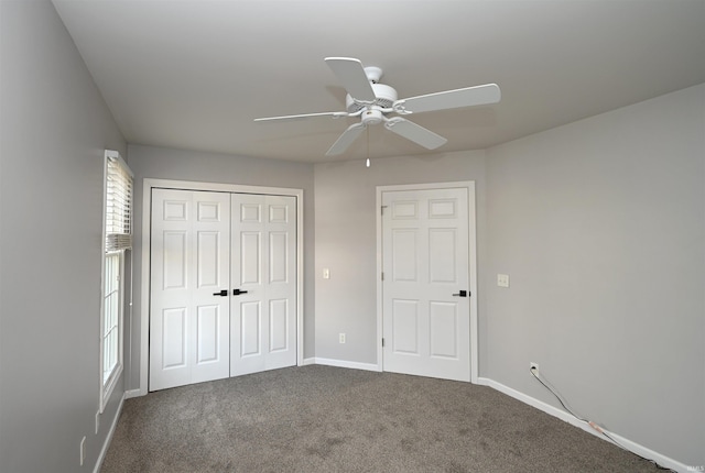 unfurnished bedroom featuring carpet floors, a closet, ceiling fan, and baseboards