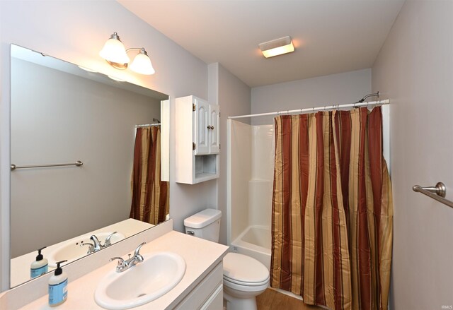 bathroom featuring toilet, shower / tub combo, and vanity