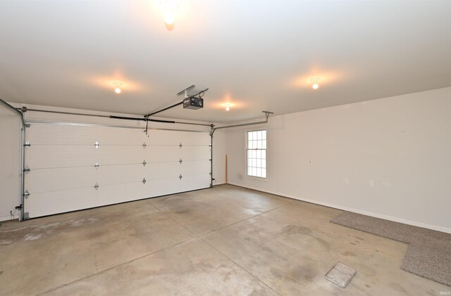 garage with a garage door opener and baseboards