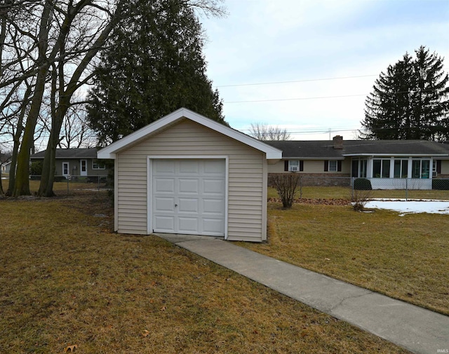 detached garage with driveway and fence