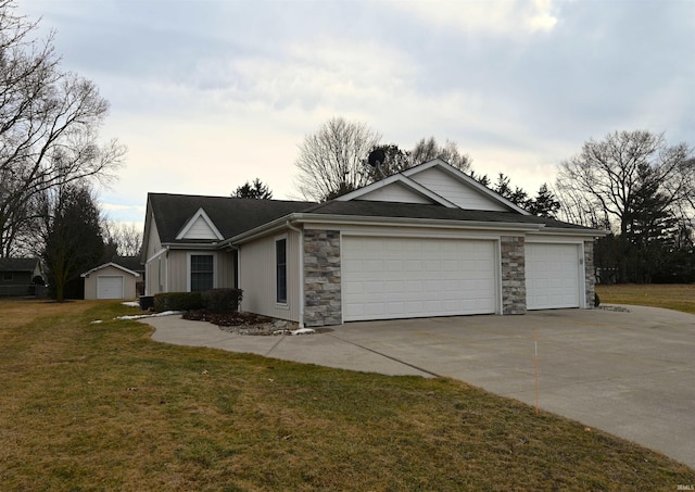 ranch-style house with stone siding, concrete driveway, and a front yard