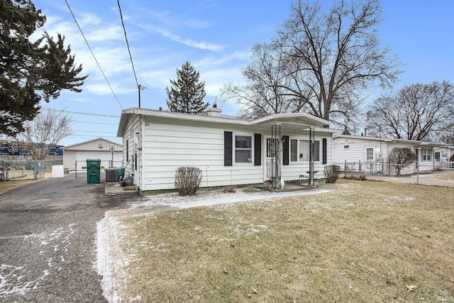 single story home with central air condition unit, fence, and a front yard