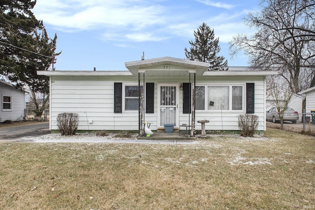 bungalow featuring a front yard and fence