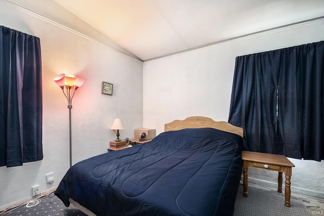 bedroom featuring lofted ceiling and carpet flooring