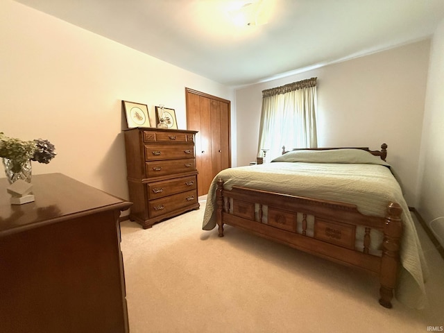 bedroom with light carpet and a closet