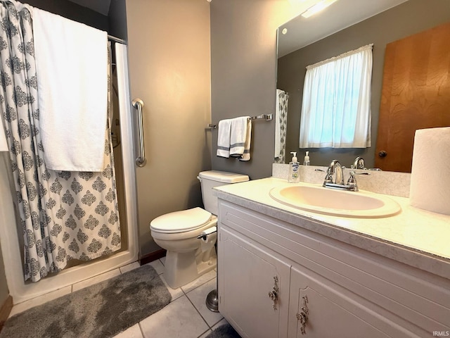 bathroom featuring toilet, tile patterned flooring, vanity, and a shower stall