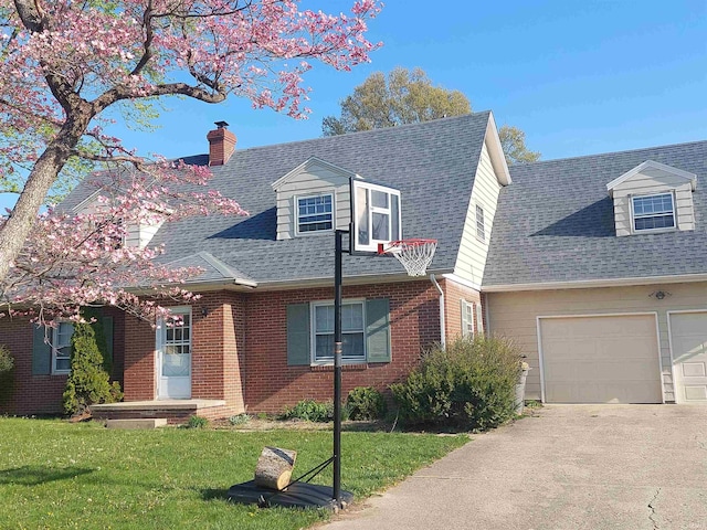 cape cod home featuring an attached garage, brick siding, concrete driveway, roof with shingles, and a front lawn