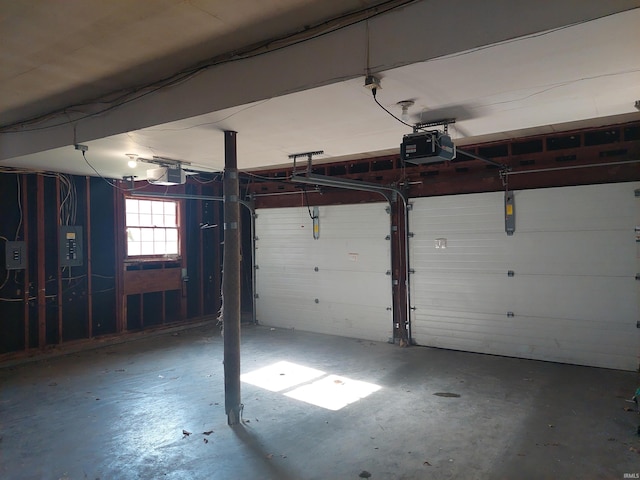 garage with electric panel and a garage door opener