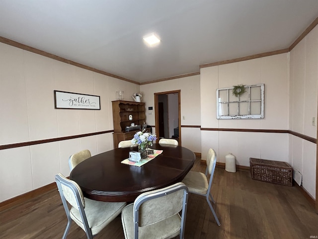 dining space featuring crown molding and wood finished floors