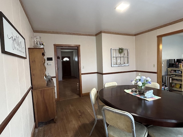 dining area featuring crown molding and wood finished floors