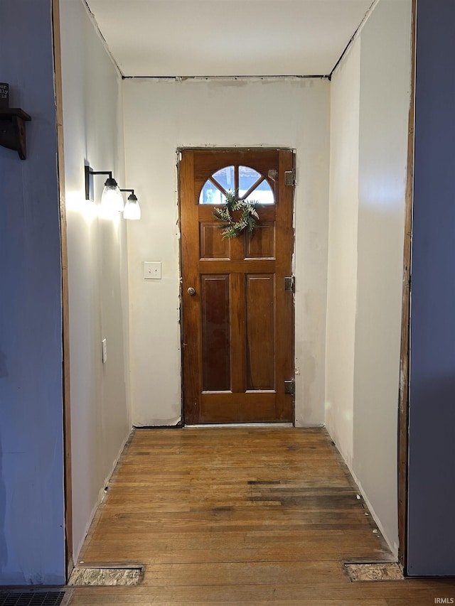 doorway to outside with wood finished floors