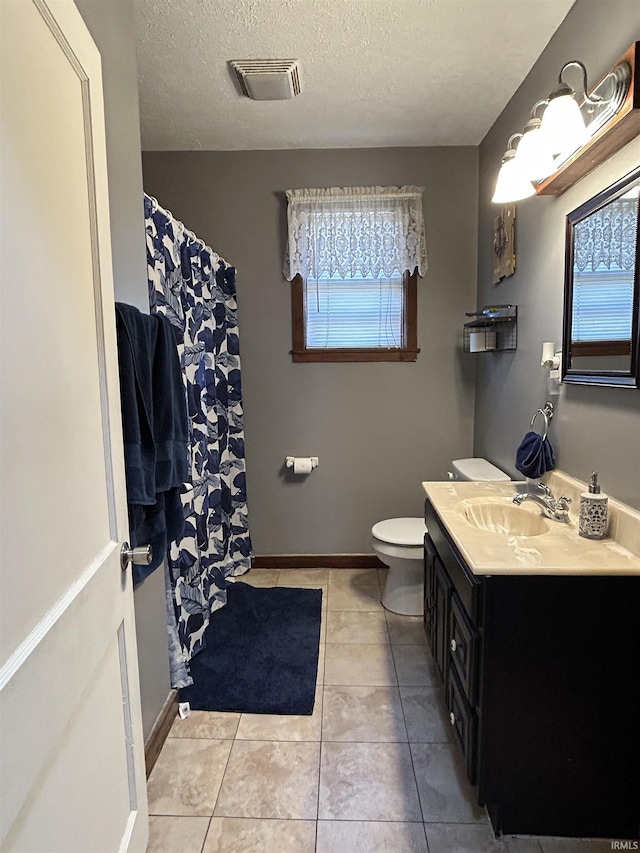 full bath with visible vents, toilet, a textured ceiling, vanity, and tile patterned flooring