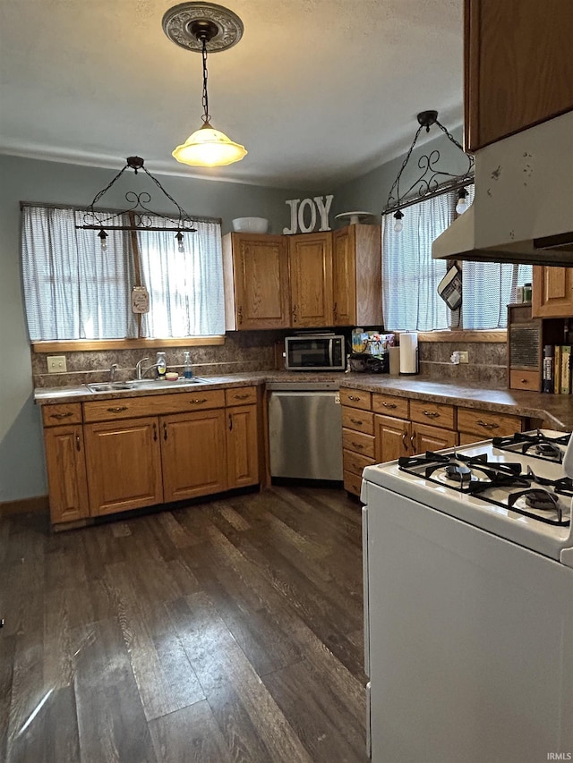 kitchen featuring dishwasher, plenty of natural light, a sink, and white range with gas cooktop