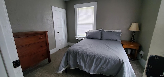 bedroom featuring carpet flooring and baseboards