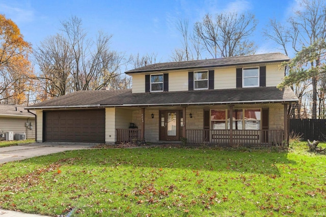 view of front of house featuring a porch, a front yard, a garage, stone siding, and driveway