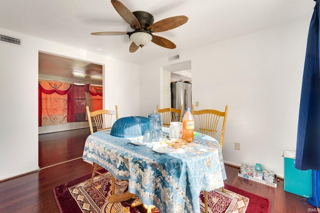 dining room with ceiling fan, dark wood-style flooring, and visible vents