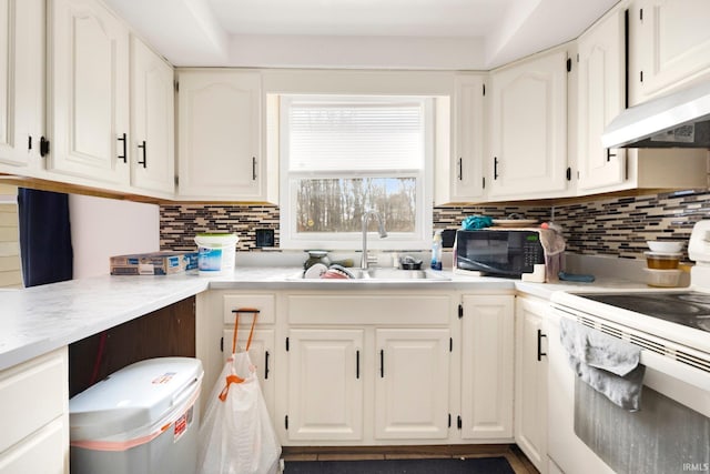 kitchen featuring a sink, white electric range, light countertops, and white cabinets