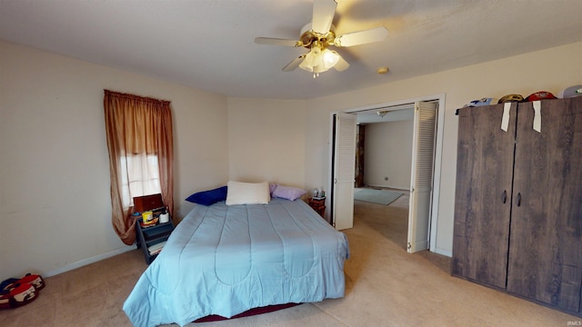 bedroom featuring light colored carpet, ceiling fan, and baseboards