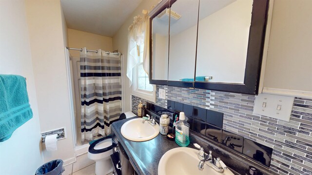 full bathroom featuring curtained shower, toilet, a sink, tile patterned floors, and tasteful backsplash