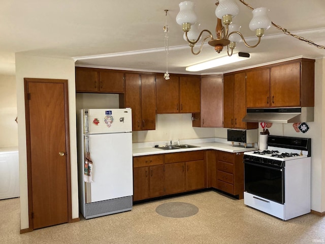 kitchen with light countertops, a sink, a chandelier, white appliances, and under cabinet range hood