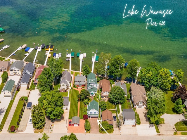 drone / aerial view featuring a water view and a residential view