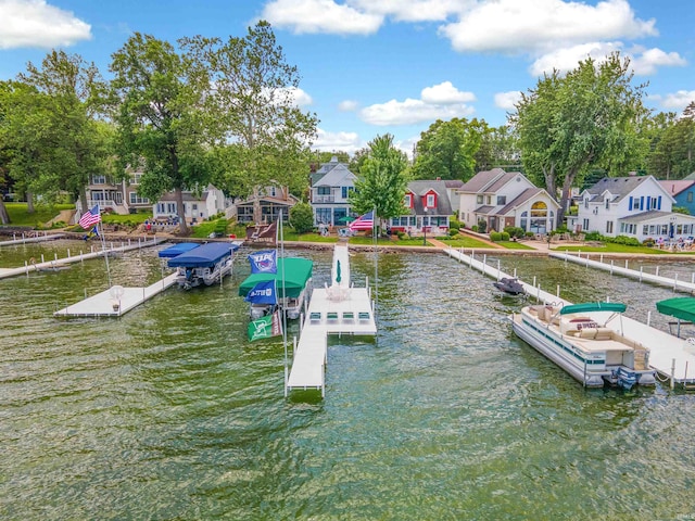 view of dock with a water view and a residential view