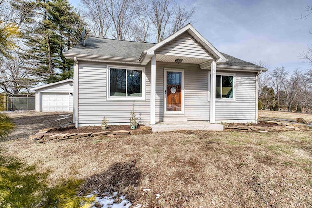 view of front of property with a front lawn and roof with shingles