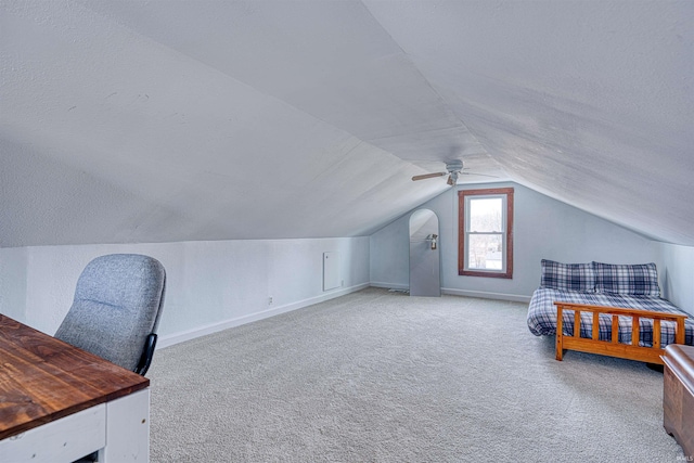 carpeted bedroom featuring lofted ceiling, ceiling fan, a textured ceiling, and baseboards