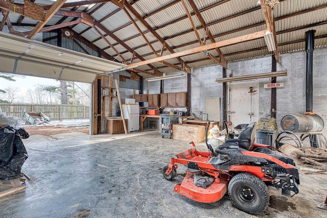 garage with freestanding refrigerator and metal wall