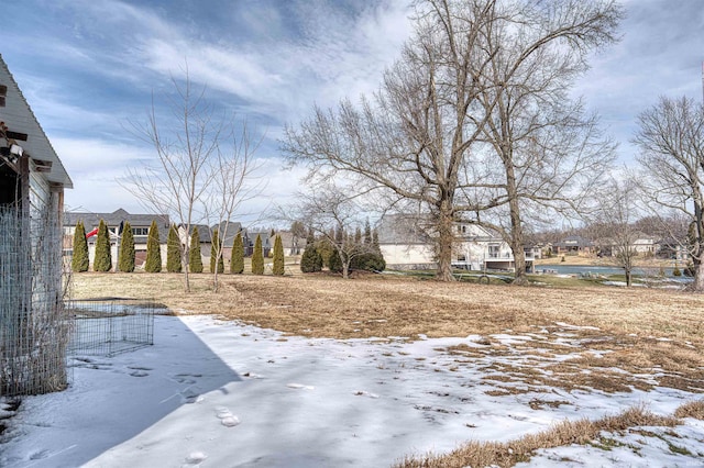 snowy yard featuring a residential view